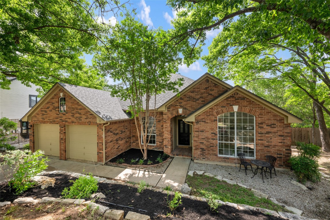 a front view of a house with a garden