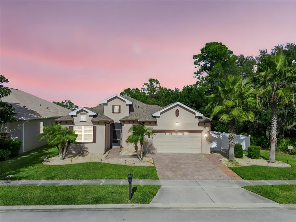 a front view of a house with a yard and garage