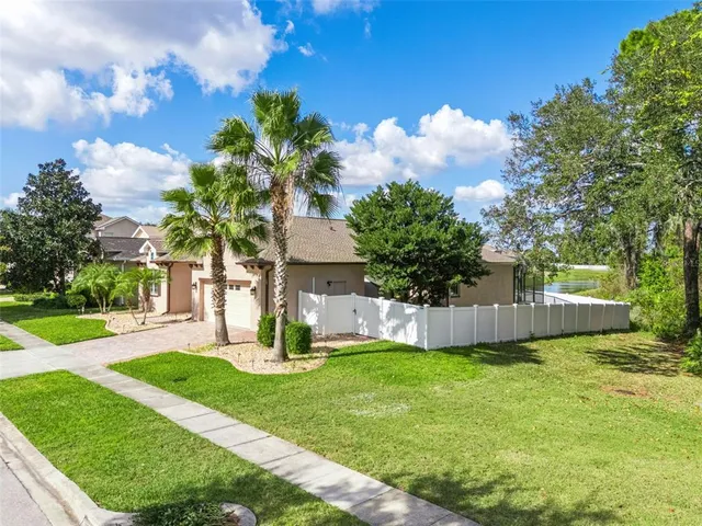 a view of a house with a yard and sitting area