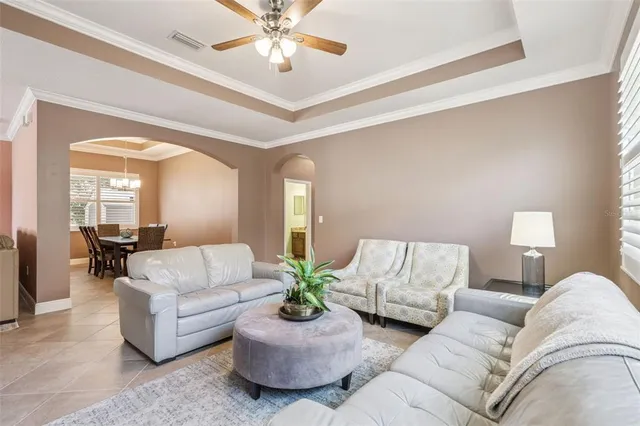 a living room with furniture and a chandelier