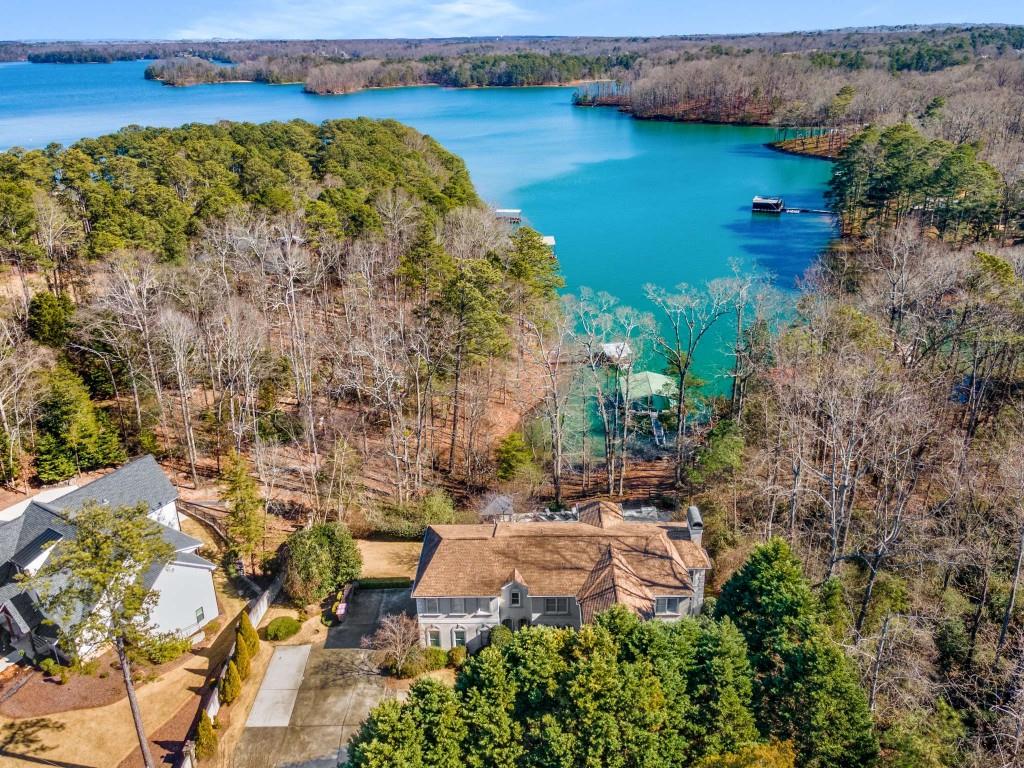 6746 Gaines Ferry Road Flowery Branch, GA 30542 - Photo 1 of 1 an aerial view of a house with a garden and lake view