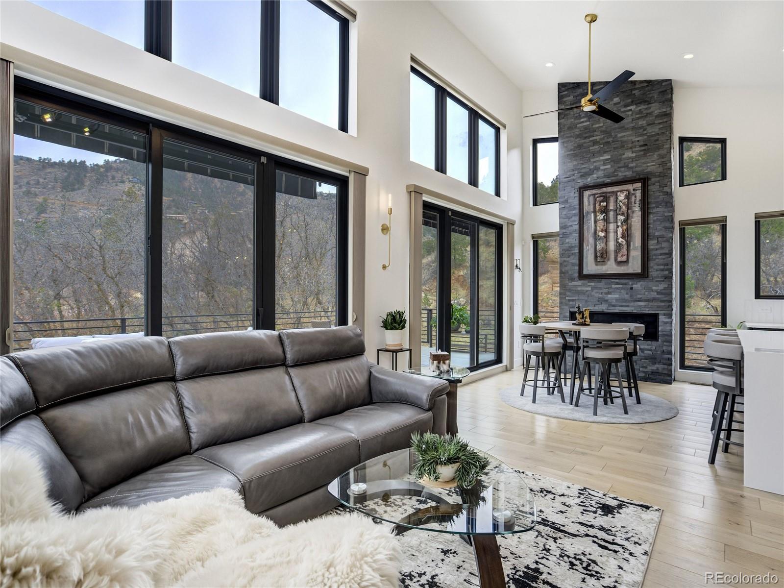 284 Crystal Park Road Manitou Springs, CO 80829 - Photo 11 of 39 a living room with furniture wooden floor and a fireplace
