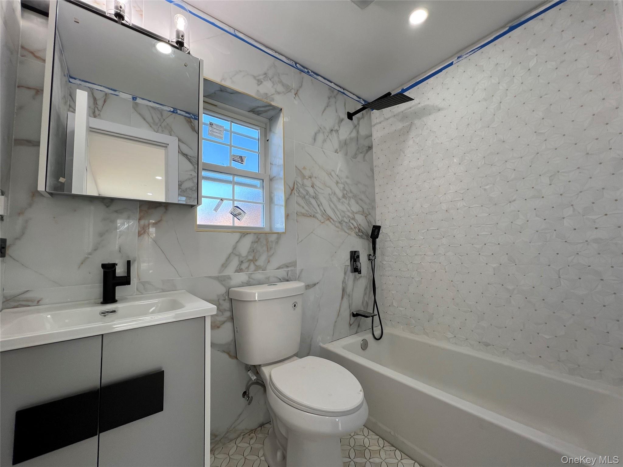 98-29 Albert Road Queens, NY 11417 - Photo 8 of 13 Full bathroom with shower / washtub combination, vanity, and tile walls