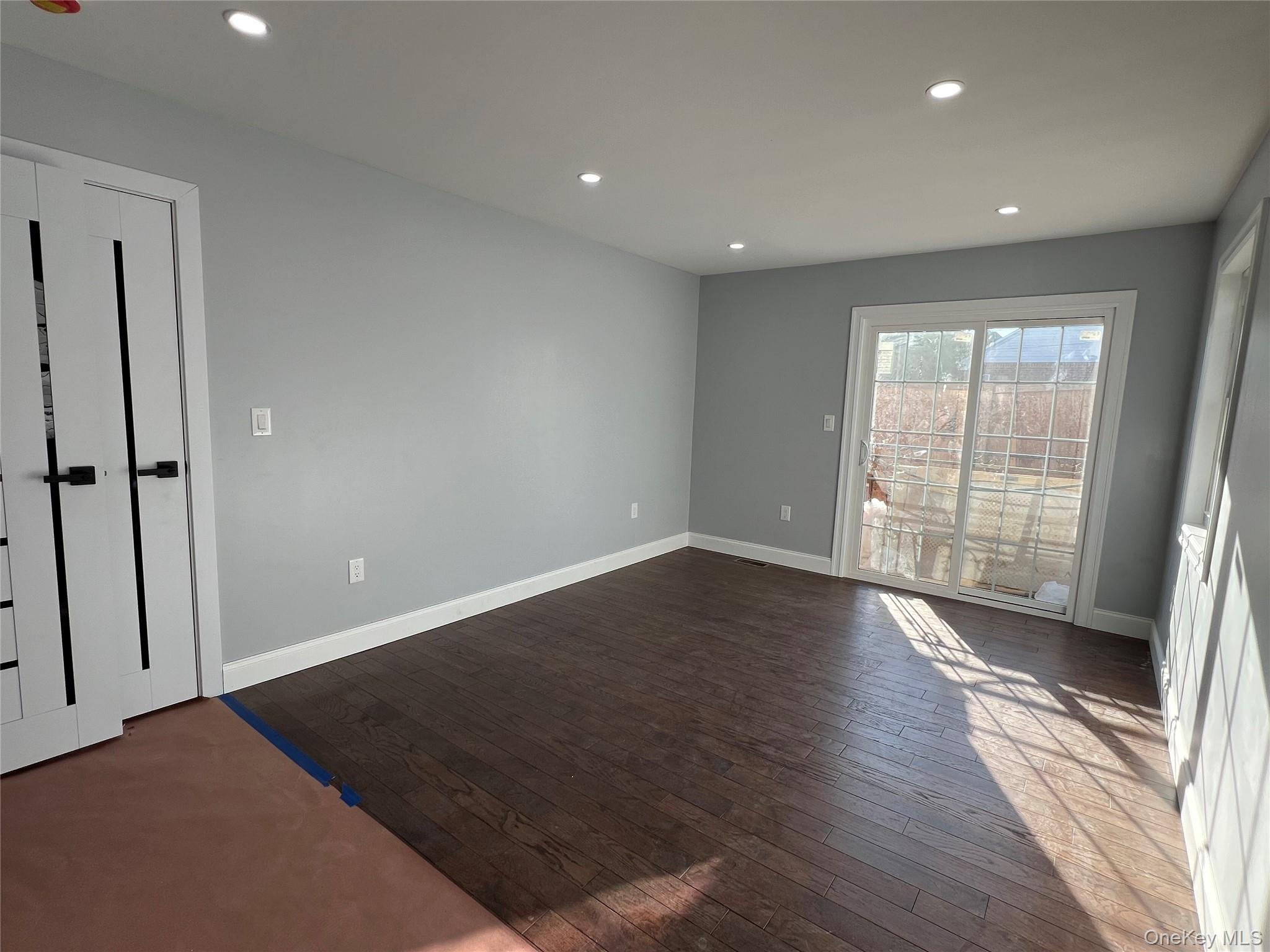 98-29 Albert Road Queens, NY 11417 - Photo 9 of 13 Empty room featuring recessed lighting and dark wood finished floors