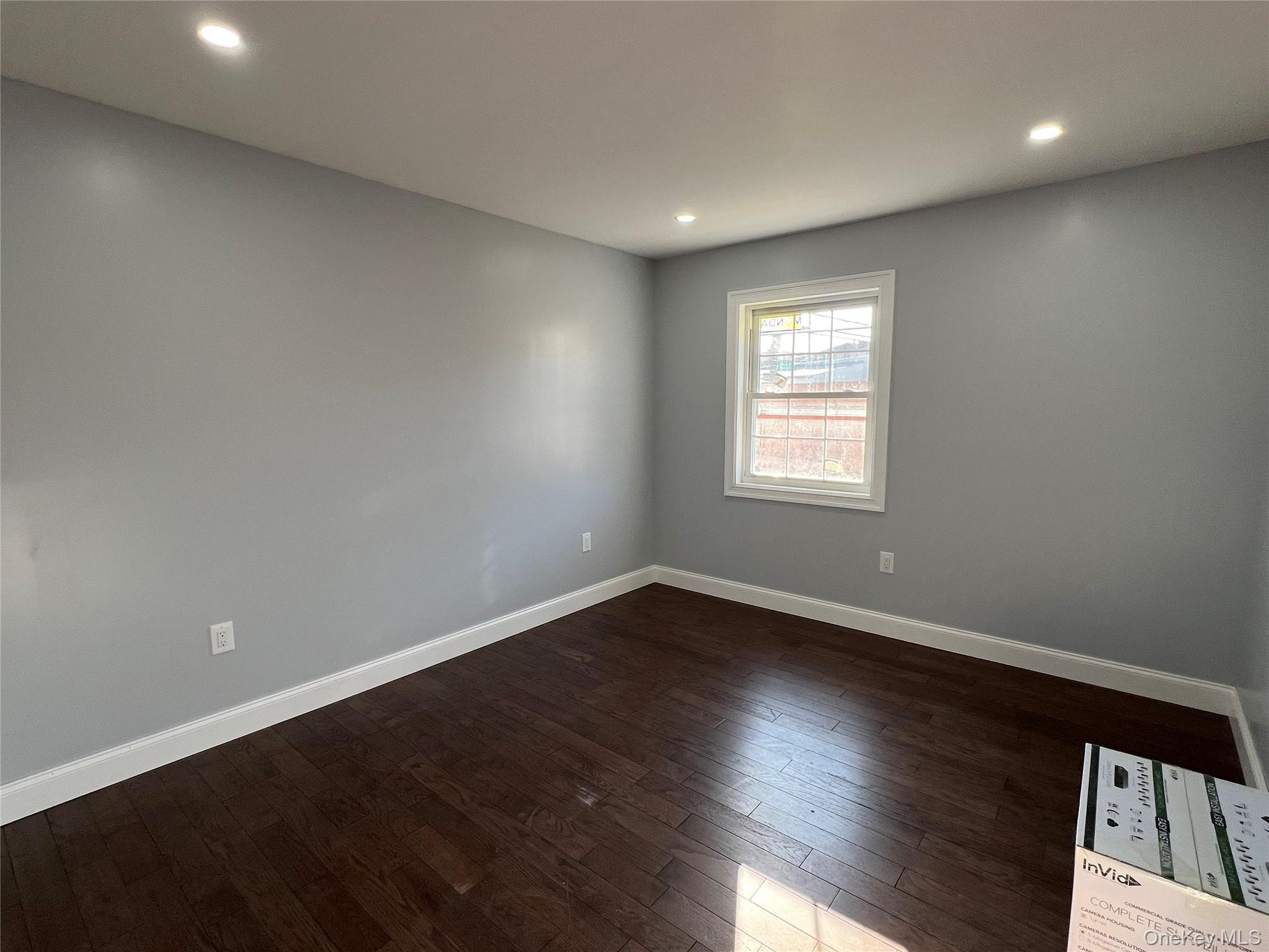 98-29 Albert Road Queens, NY 11417 - Photo 10 of 13 Unfurnished room with dark wood-style floors and recessed lighting