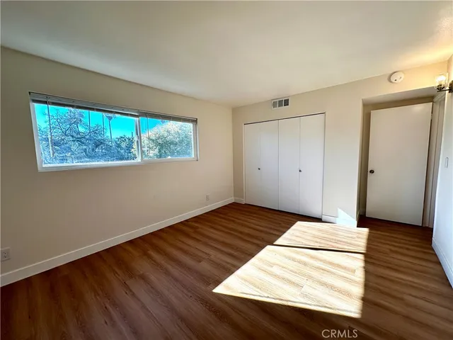 a view of wooden floor and windows in a room