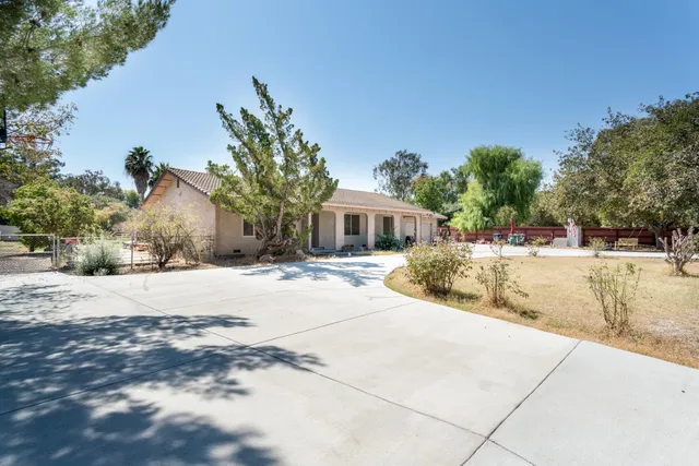 a view of a house with palm trees