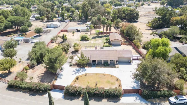 an aerial view of a house with yard