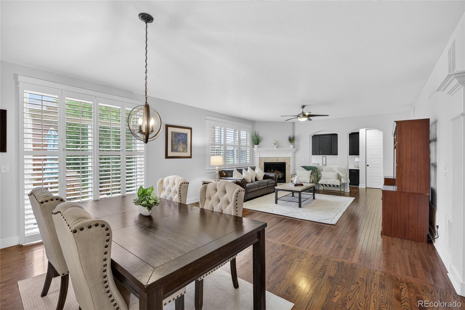 20554 East Shady Ridge Road Parker, CO 80134 - Photo 10 of 49 a view of a dining room and livingroom with furniture wooden floor a chandelier
