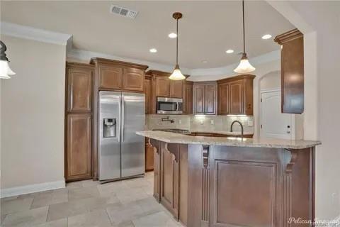 2805 Clearbrook Way Haughton, LA 71037 - Photo 9 of 33 a kitchen with kitchen island a sink and refrigerator