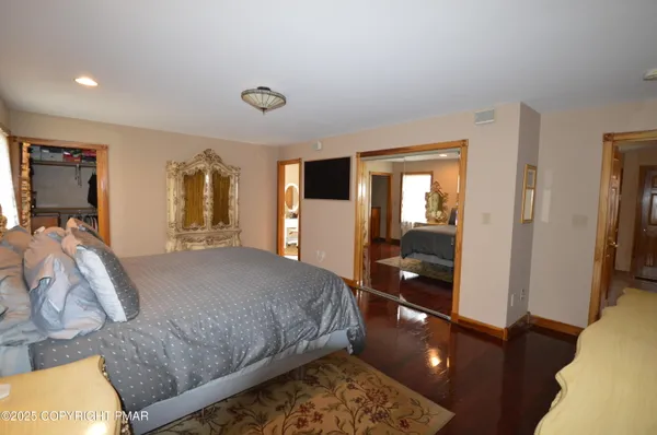 a bedroom with a bed and a view of living room