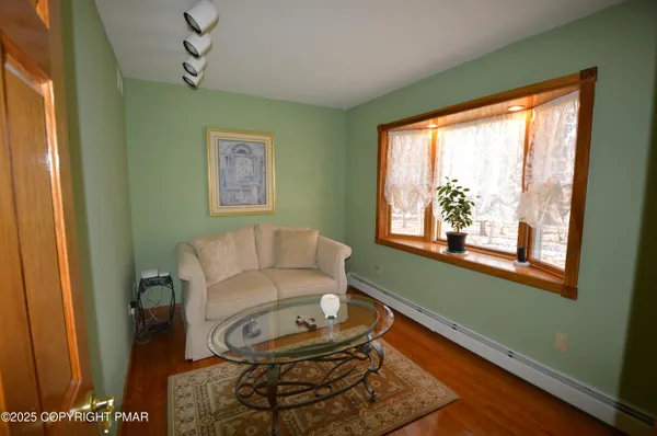 a dining hall with stainless steel appliances a dining table and chairs with wooden floor