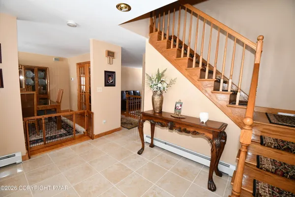 a living room with a flat screen tv and a rug