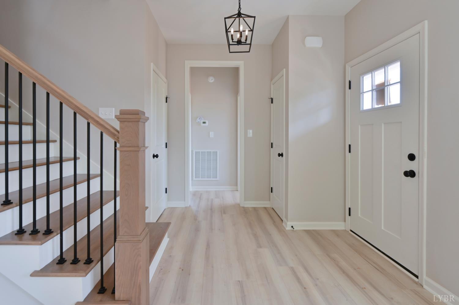 1833 Crockett Road Forest, VA 24551 - Photo 14 of 32 a view of a hallway with wooden floor and stairs