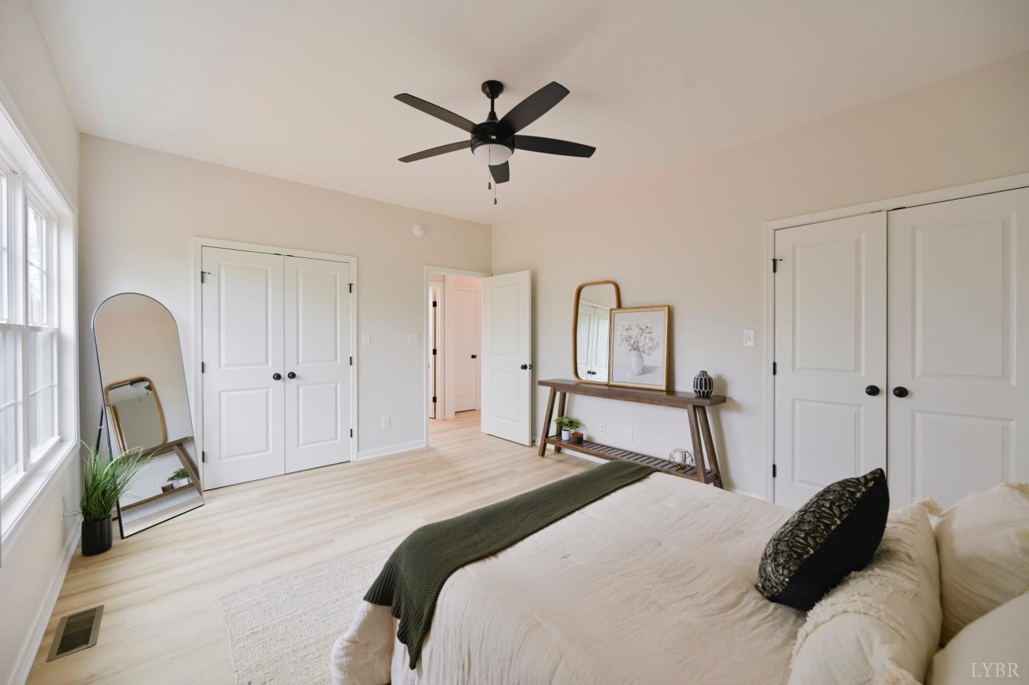 1833 Crockett Road Forest, VA 24551 - Photo 17 of 32 a bedroom with a bed and a chandelier