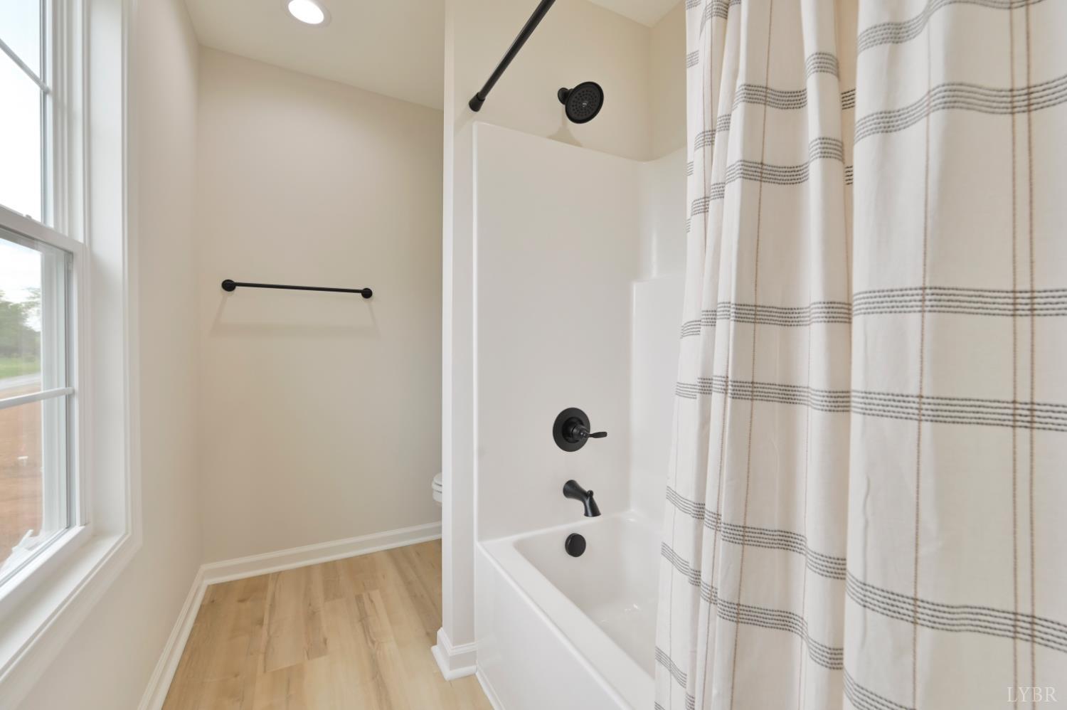 1833 Crockett Road Forest, VA 24551 - Photo 23 of 32 a bathroom with a bathtub and a shower