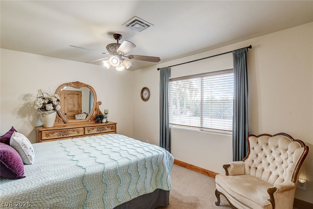 1950 Bowman Road Logandale, NV 89021 - Photo 42 of 81 Naturally illuminated bedroom features comfortable carpeting and a multi-speed ceiling fan for optimal airflow.