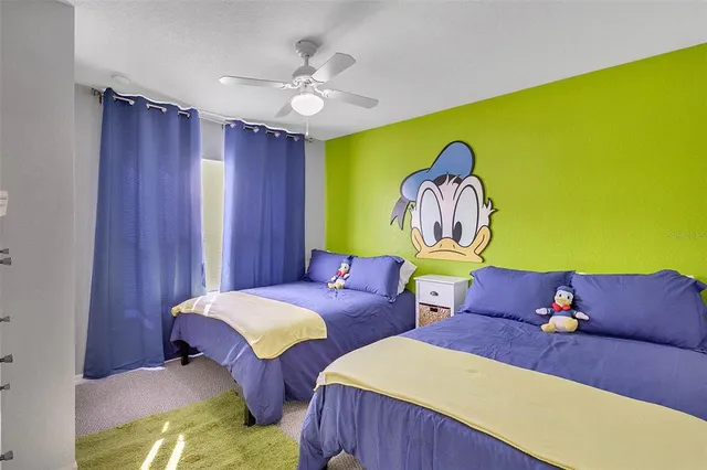 a living room with two chairs and a lamp