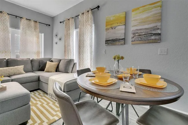 a view of a dining room with furniture and a window