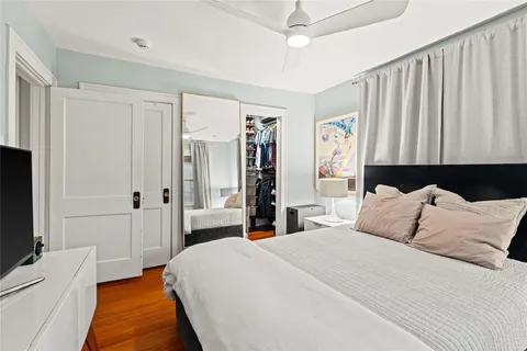 a view of a room with furniture and wooden floor
