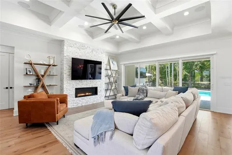a living room with furniture ceiling fan and a wooden floor