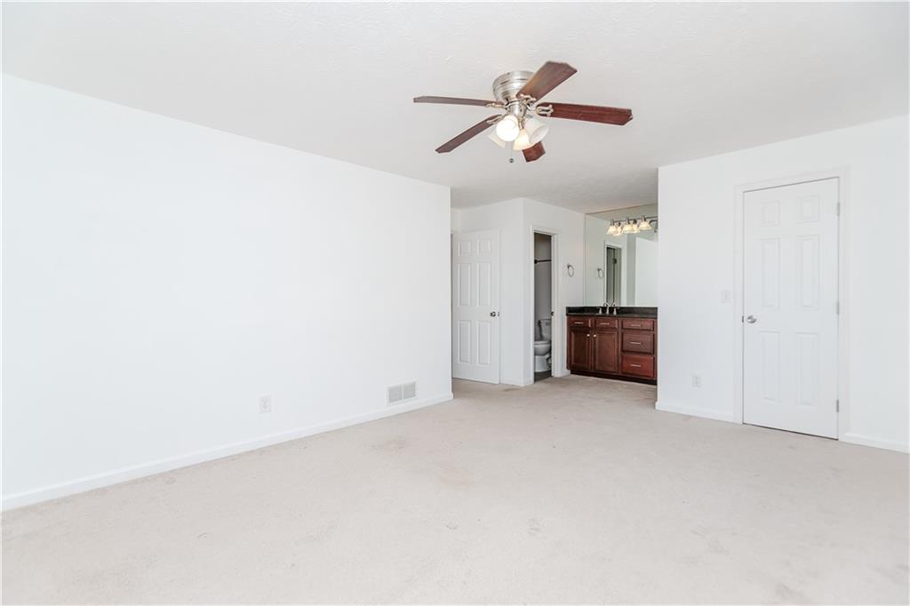 3408 Hamilton Mill Road Buford, GA 30519 - Photo 12 of 32 an empty room with windows and chandelier fan