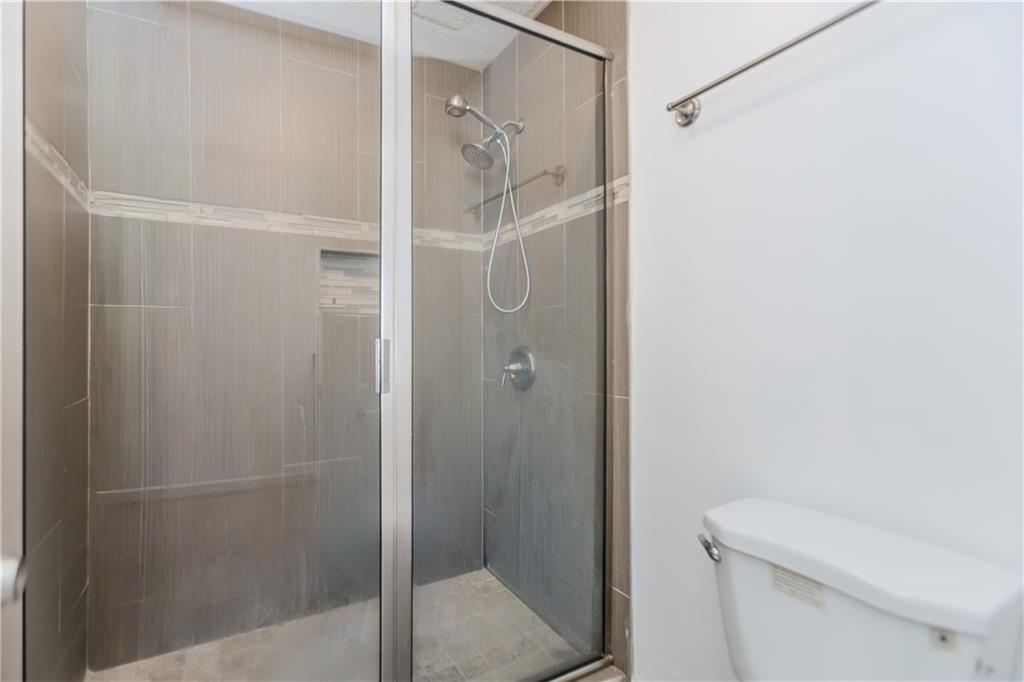 3408 Hamilton Mill Road Buford, GA 30519 - Photo 15 of 32 a bathroom with a shower and toilet