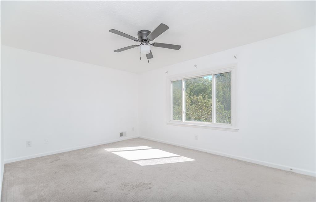 3408 Hamilton Mill Road Buford, GA 30519 - Photo 16 of 32 an empty room with a window and a fan