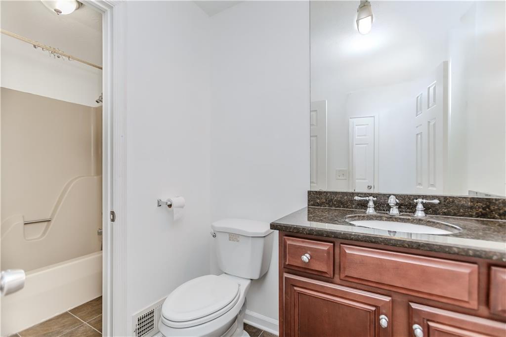 3408 Hamilton Mill Road Buford, GA 30519 - Photo 18 of 32 a bathroom with a granite countertop toilet sink and mirror