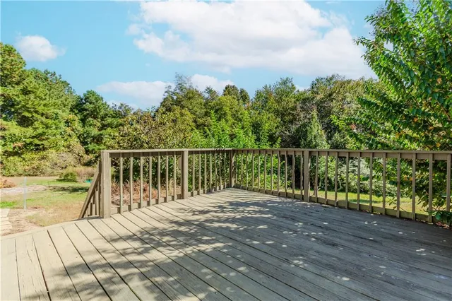 a balcony with wooden floor and fence