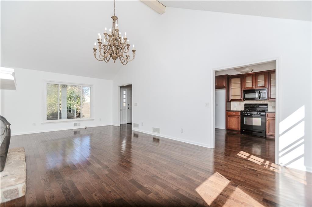 3408 Hamilton Mill Road Buford, GA 30519 - Photo 6 of 32 a view of an empty room with window and wooden floor