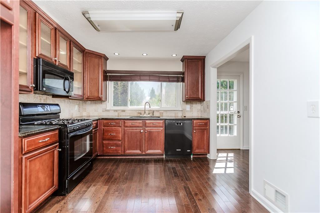 3408 Hamilton Mill Road Buford, GA 30519 - Photo 9 of 32 a kitchen with stainless steel appliances granite countertop wooden cabinets a refrigerator a stove a sink and a microwave