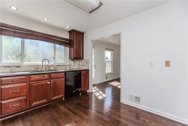 a spacious bathroom with a granite countertop sink and a large mirror
