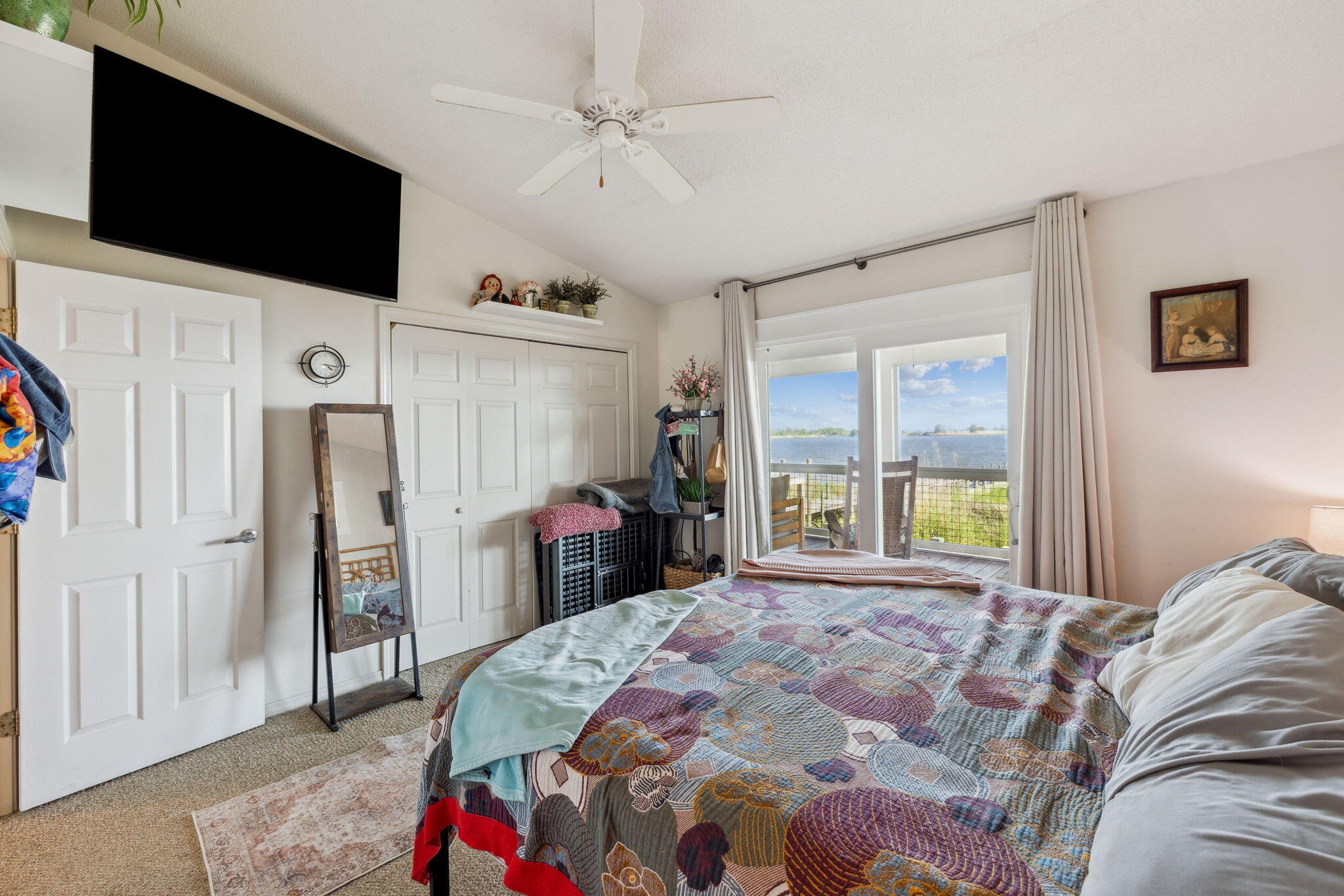 227 Shady Lane Freeport, FL 32439 - Photo 16 of 32 a bedroom with a bed a window and a flat screen television