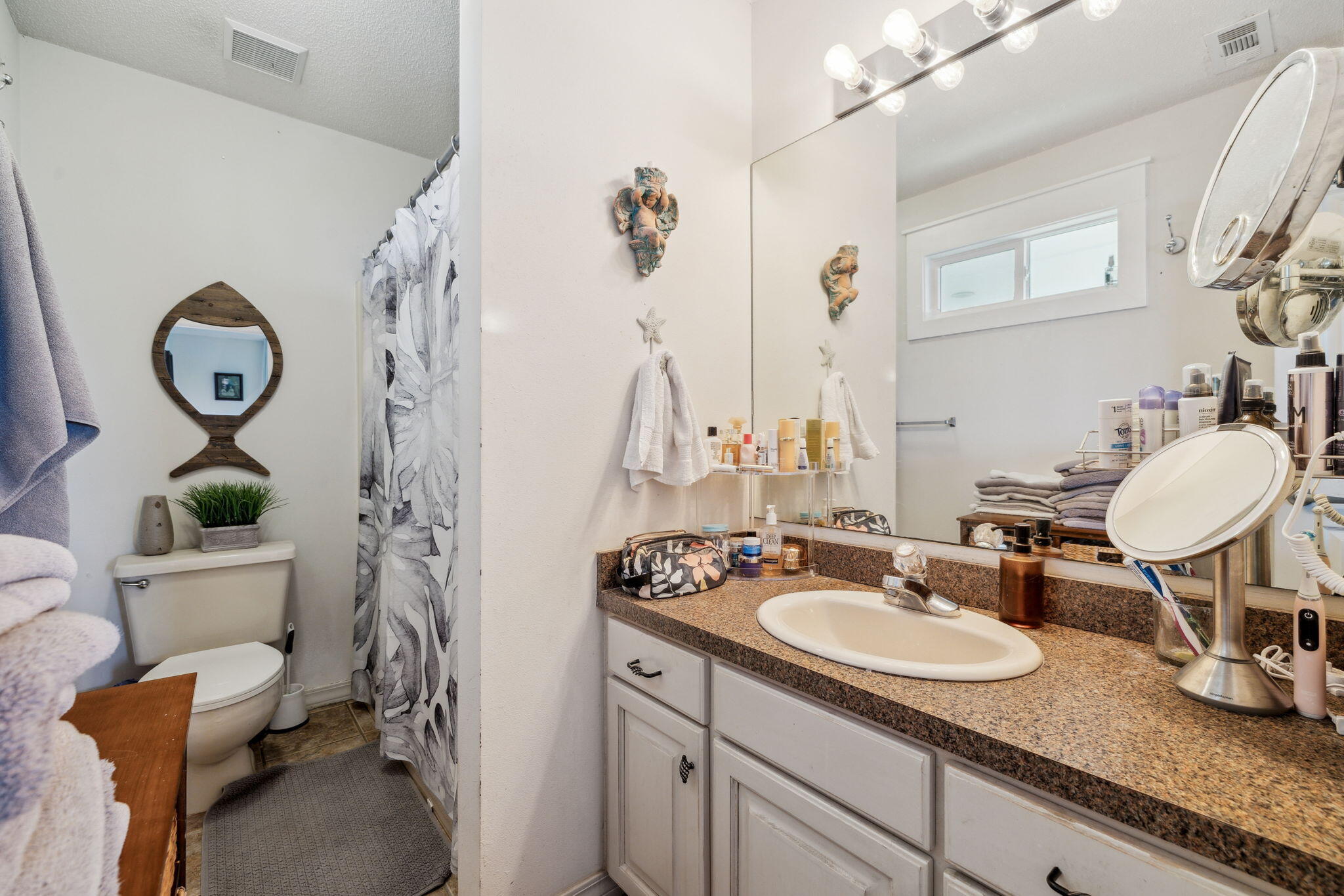 227 Shady Lane Freeport, FL 32439 - Photo 17 of 32 a bathroom with a granite countertop sink mirror vanity and toilet