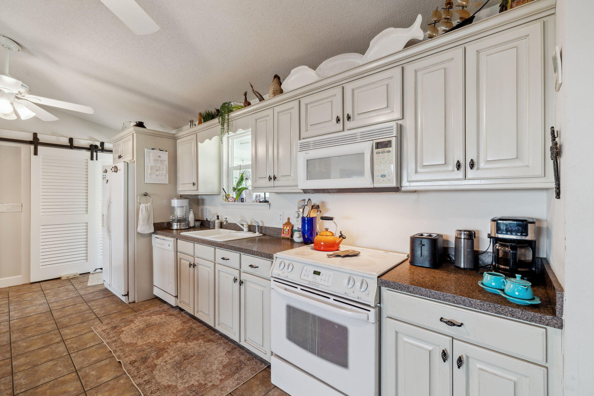 227 Shady Lane Freeport, FL 32439 - Photo 8 of 32 a kitchen with stainless steel appliances white cabinets and a stove top oven