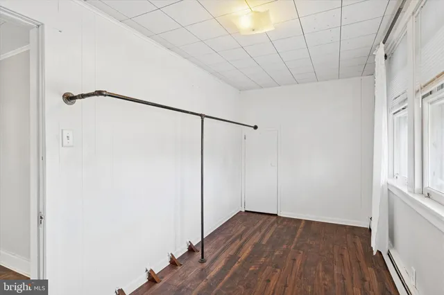 a view of a room with wooden floor