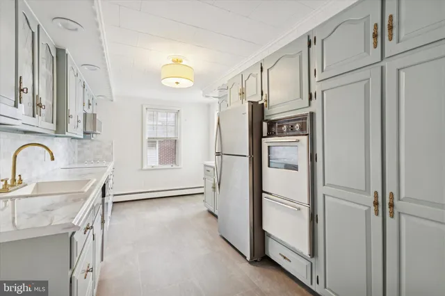 a kitchen with stainless steel appliances granite countertop a refrigerator and a sink
