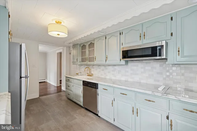 a kitchen with cabinets appliances and a sink