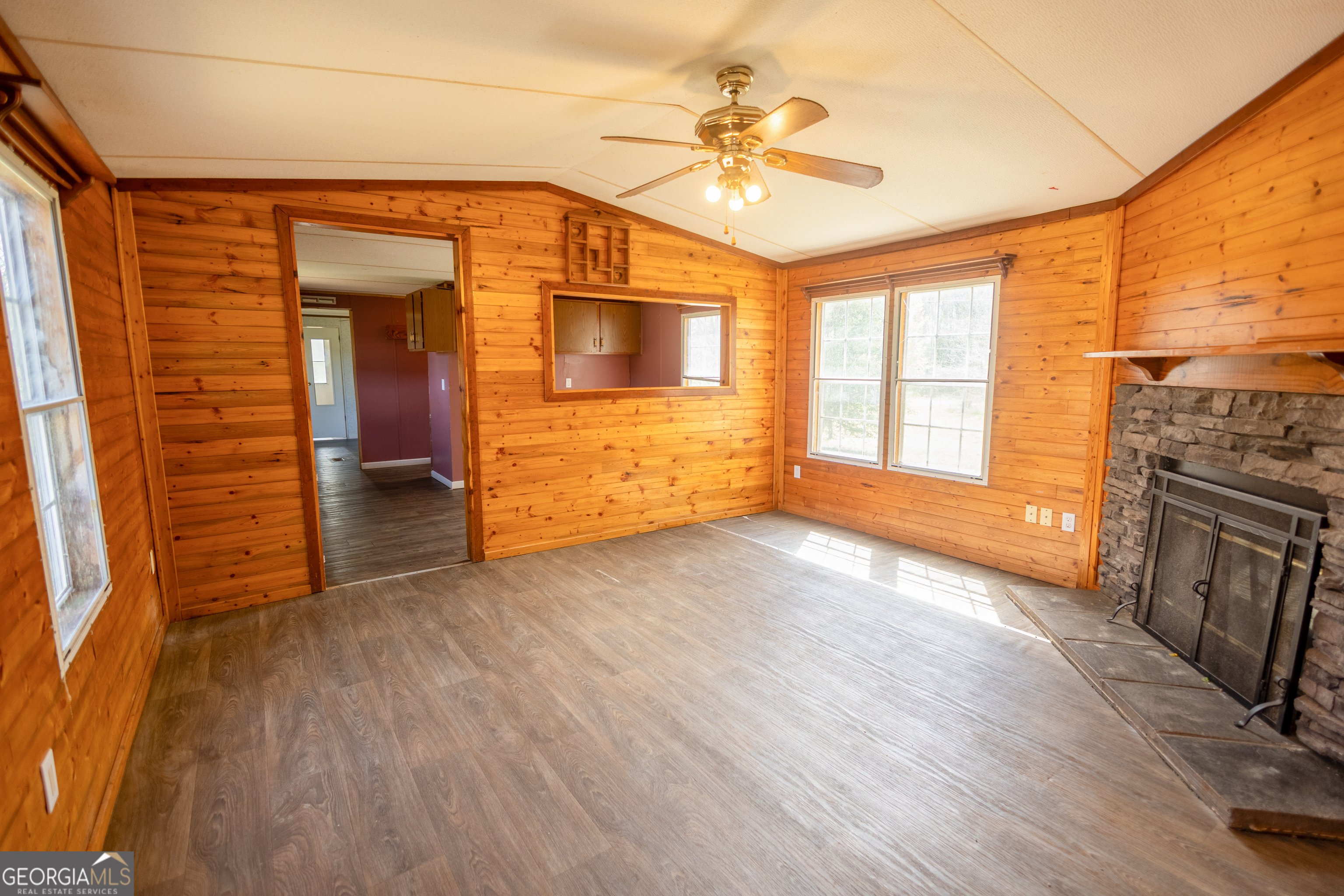 35 Brooks Street Canon, GA 30520 - Photo 3 of 25 a view of an empty room with a fireplace and wooden floor