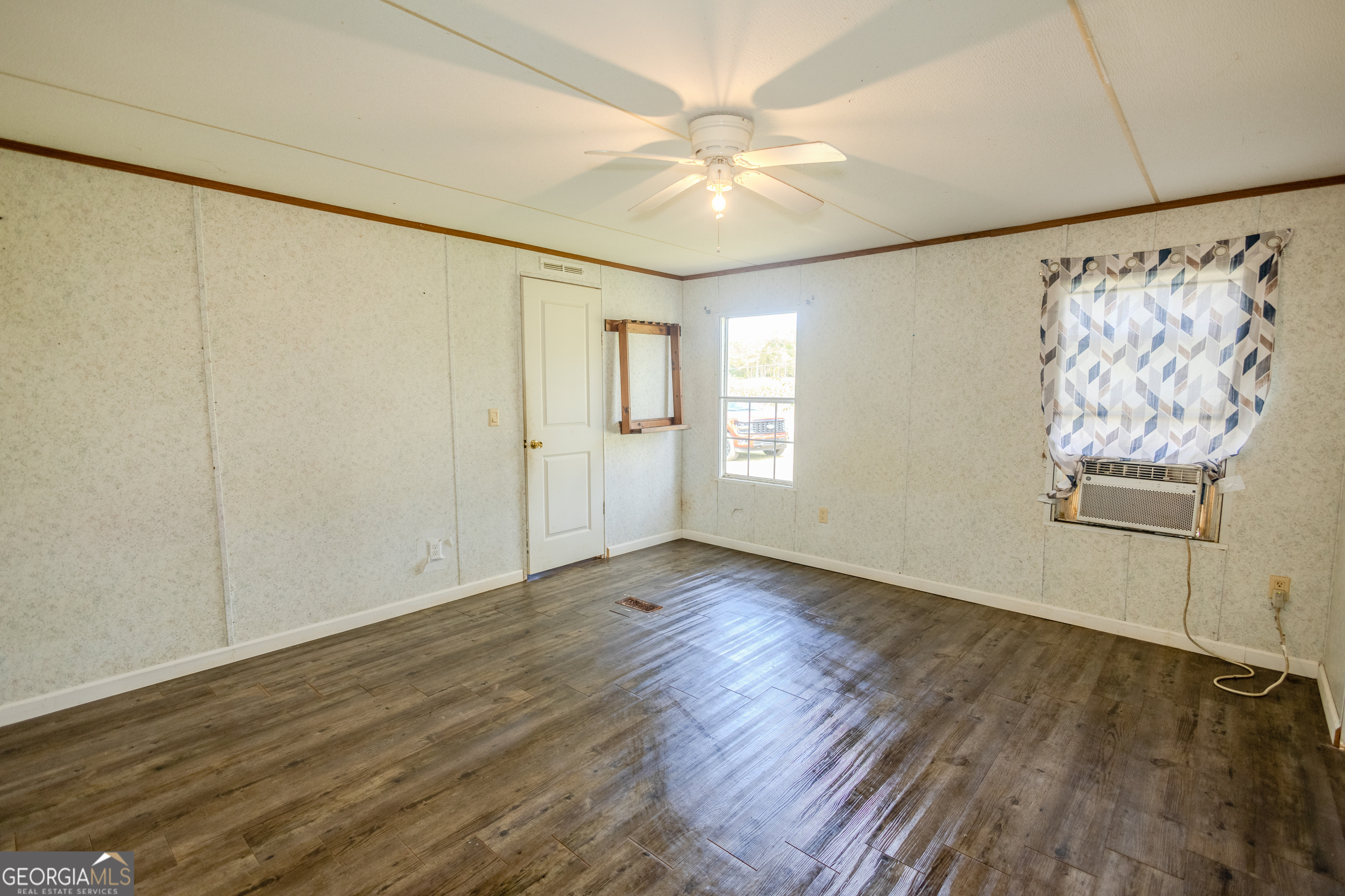 35 Brooks Street Canon, GA 30520 - Photo 10 of 25 a view of an empty room with a window and wooden floor