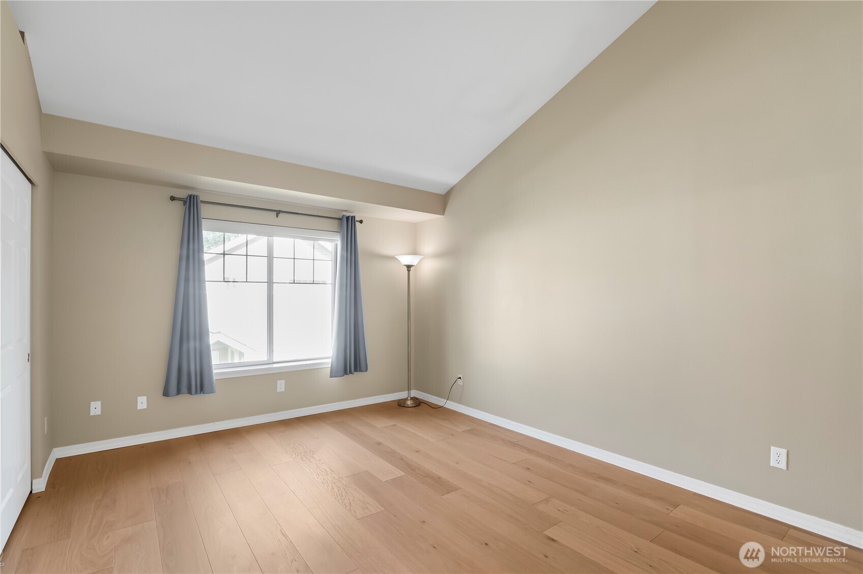 1522 196th Street Southeast, Unit C103 Bothell, WA 98012 - Photo 12 of 24 an empty room with wooden floor and windows