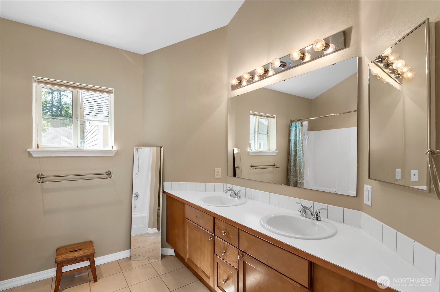 1522 196th Street Southeast, Unit C103 Bothell, WA 98012 - Photo 13 of 24 a spacious bathroom with a double vanity sink a mirror and a shower
