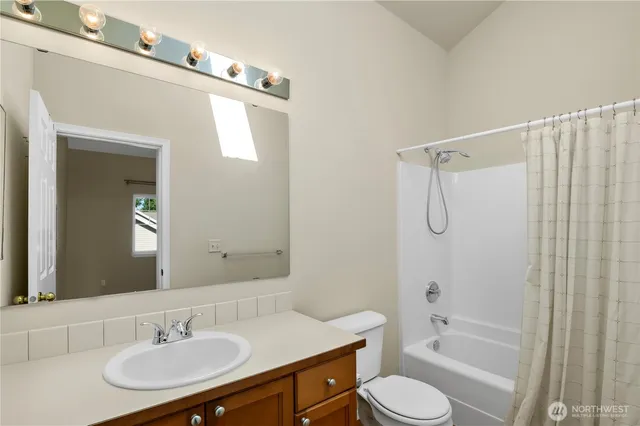 a bathroom with a sink toilet tub and shower