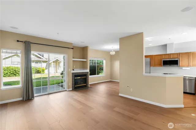 an empty room with wooden floor and fireplace