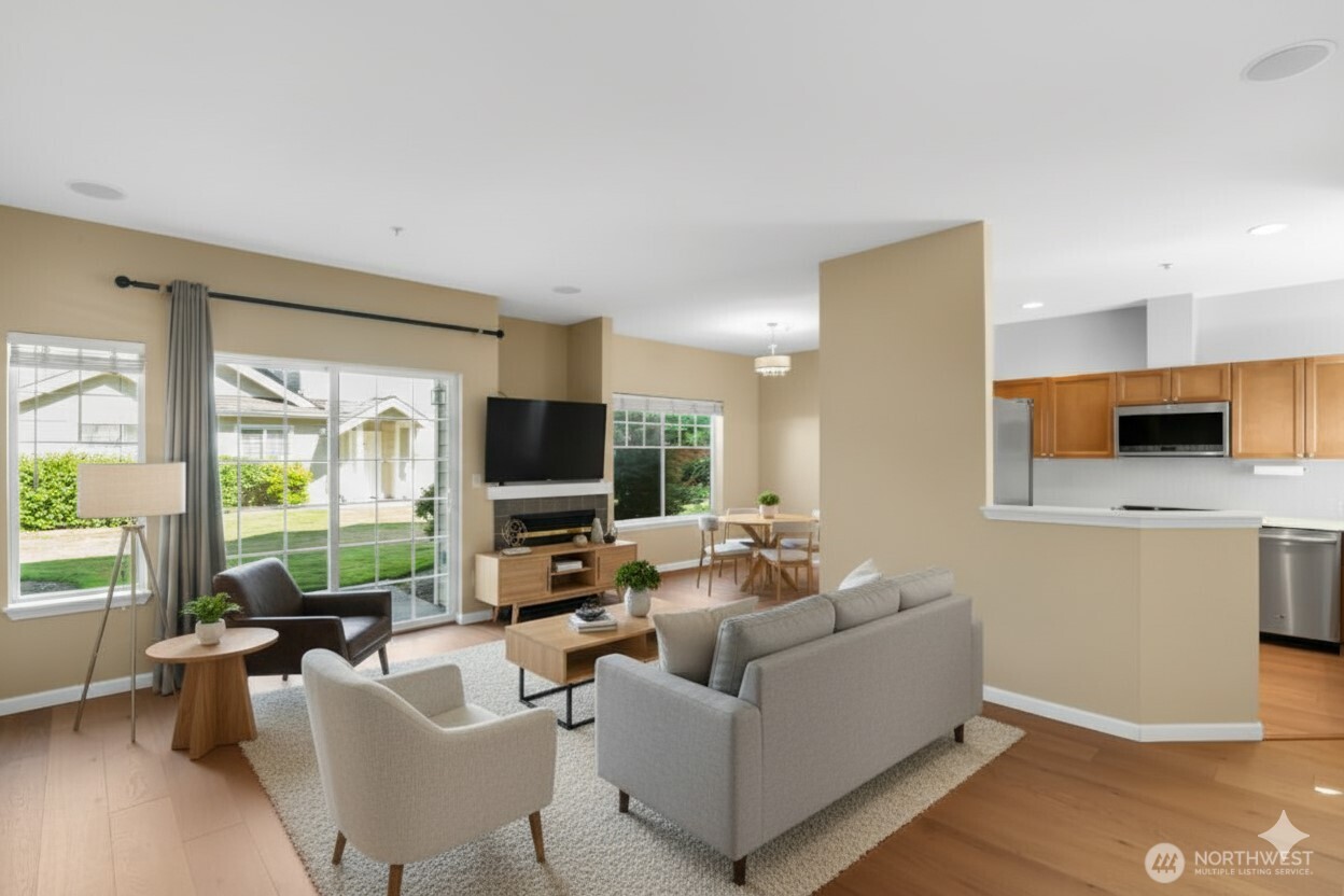 1522 196th Street Southeast, Unit C103 Bothell, WA 98012 - Photo 6 of 24 a living room with furniture flat screen tv and a large window