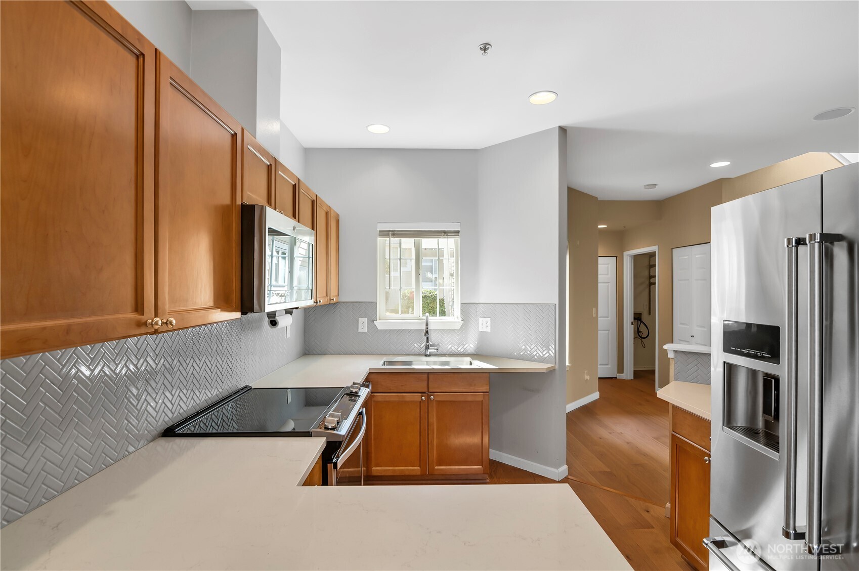 1522 196th Street Southeast, Unit C103 Bothell, WA 98012 - Photo 8 of 24 a living room with stainless steel appliances furniture and a kitchen view