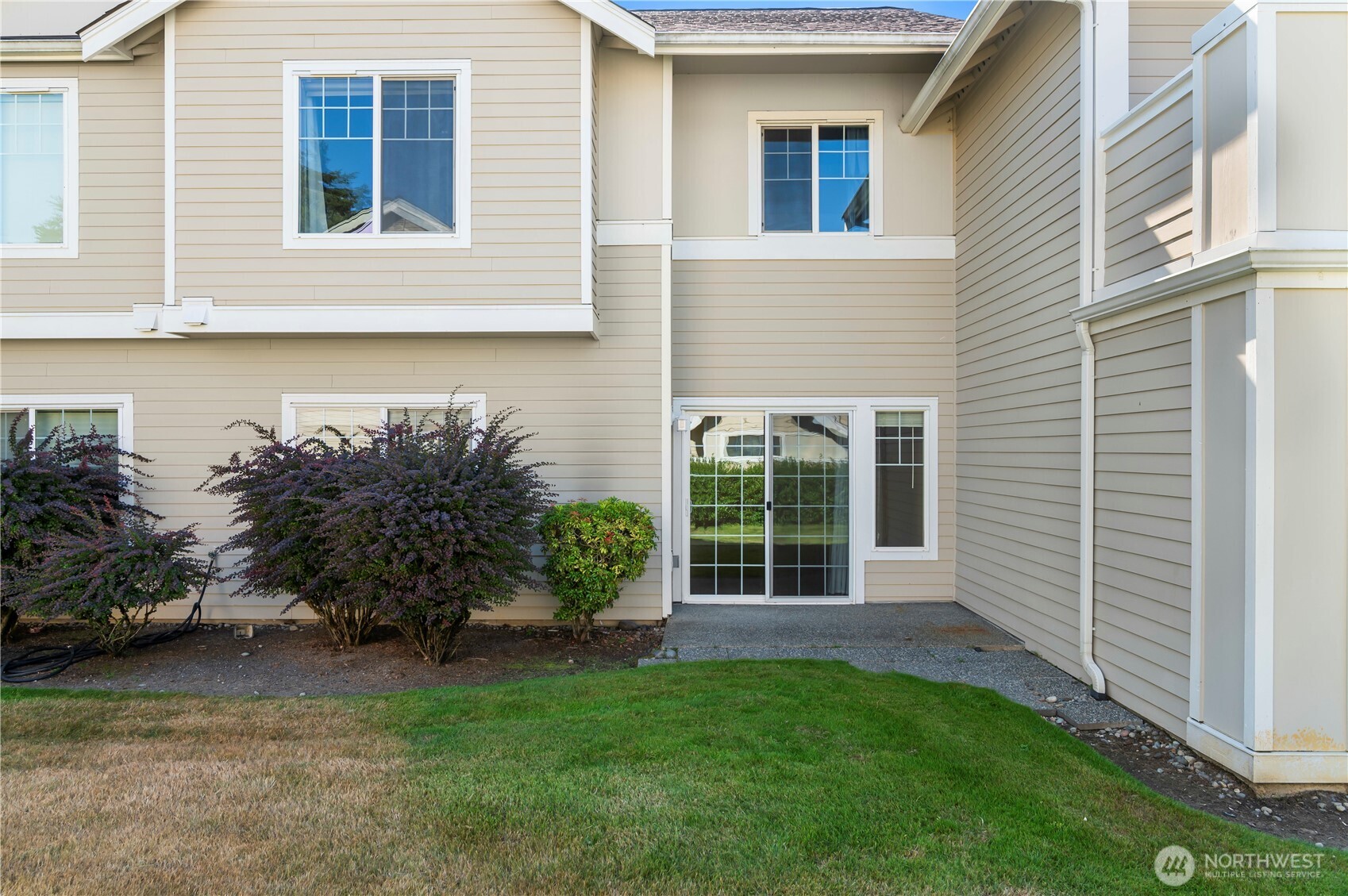 1522 196th Street Southeast, Unit C103 Bothell, WA 98012 - Photo 9 of 24 a view of a backyard with plants and large tree