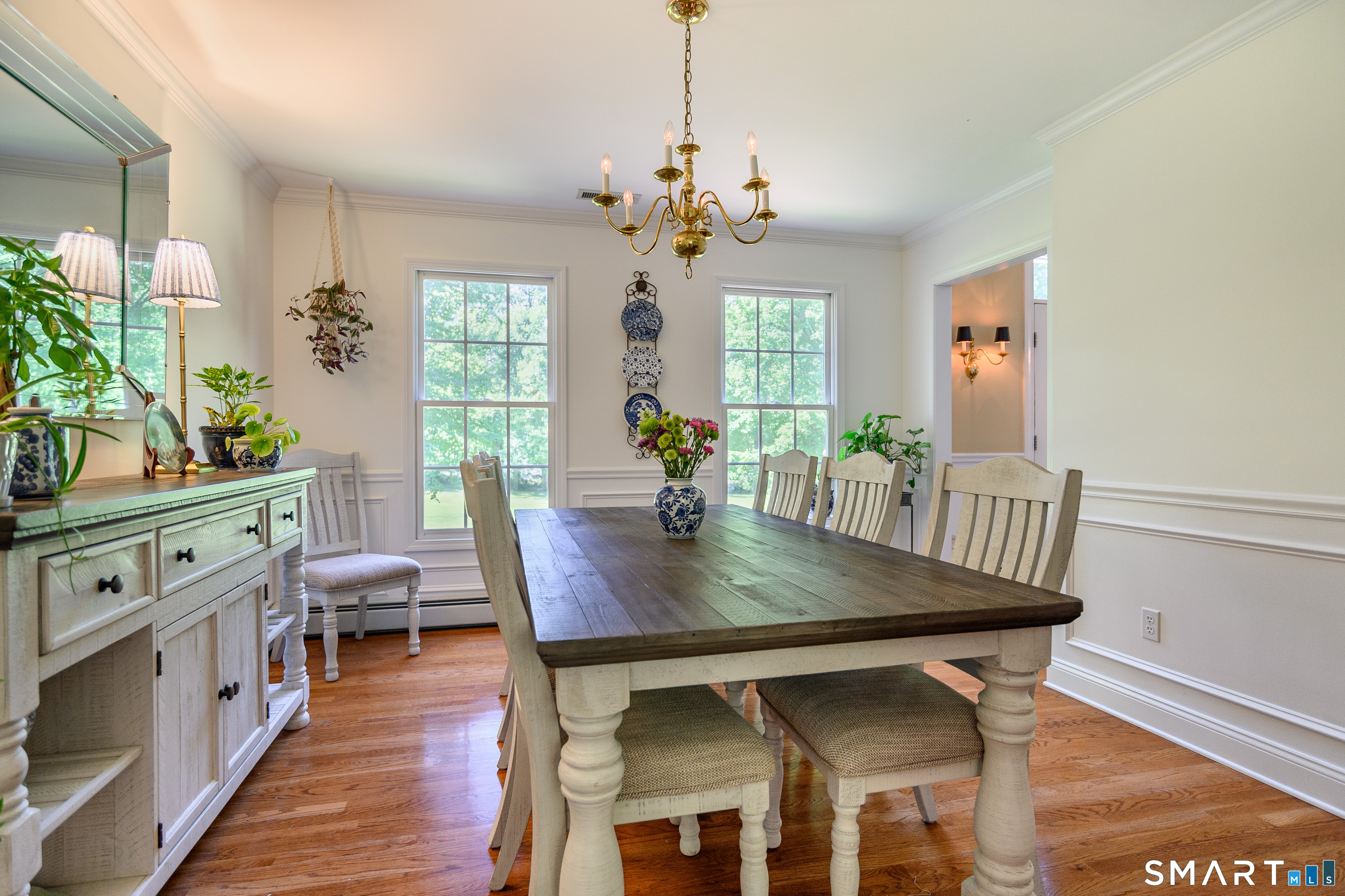 21 Phyllis Lane Newtown, CT 06470 - Photo 14 of 40 Dining room with hardwood floors, chair rail molding, and classic chandelier.