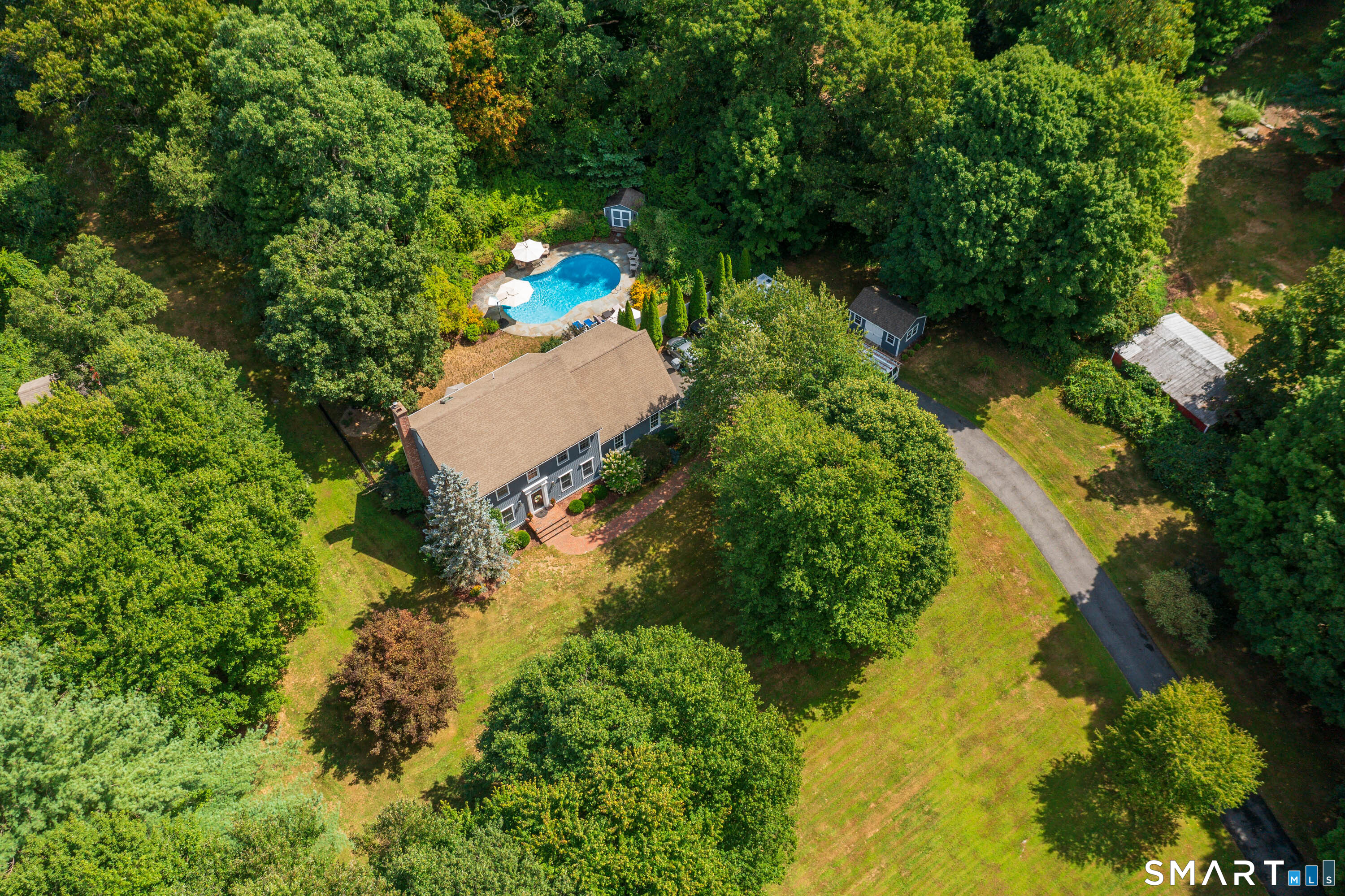 21 Phyllis Lane Newtown, CT 06470 - Photo 2 of 40 Aerial view highlighting private setting, in-ground pool, and surrounding wooded landscape.
